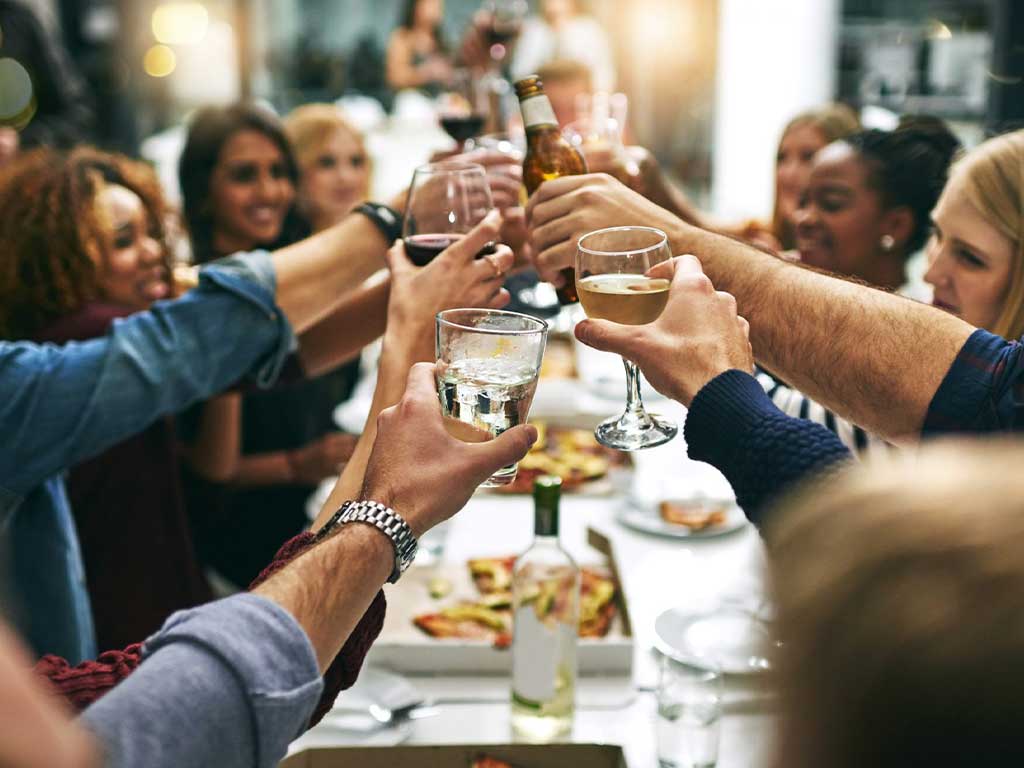 A gathering of individuals raising their glasses.