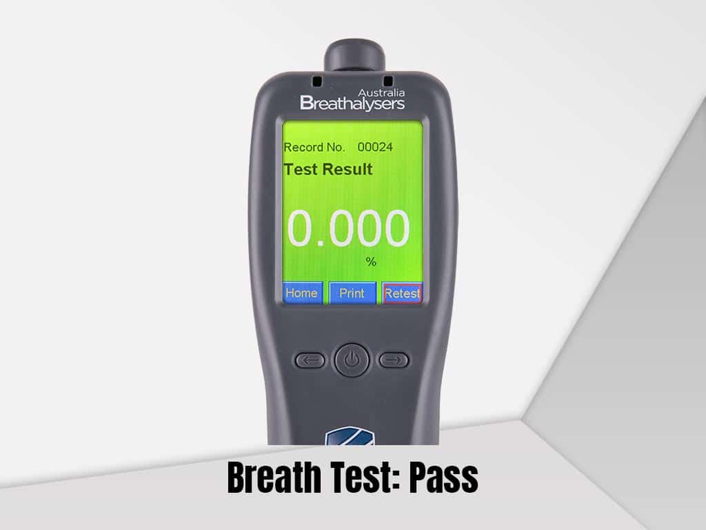 A breathalyser device showing a passing result.