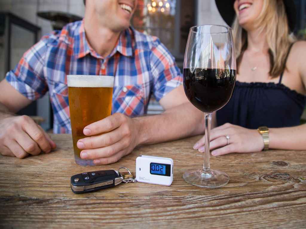 Two people dining and a breath tester