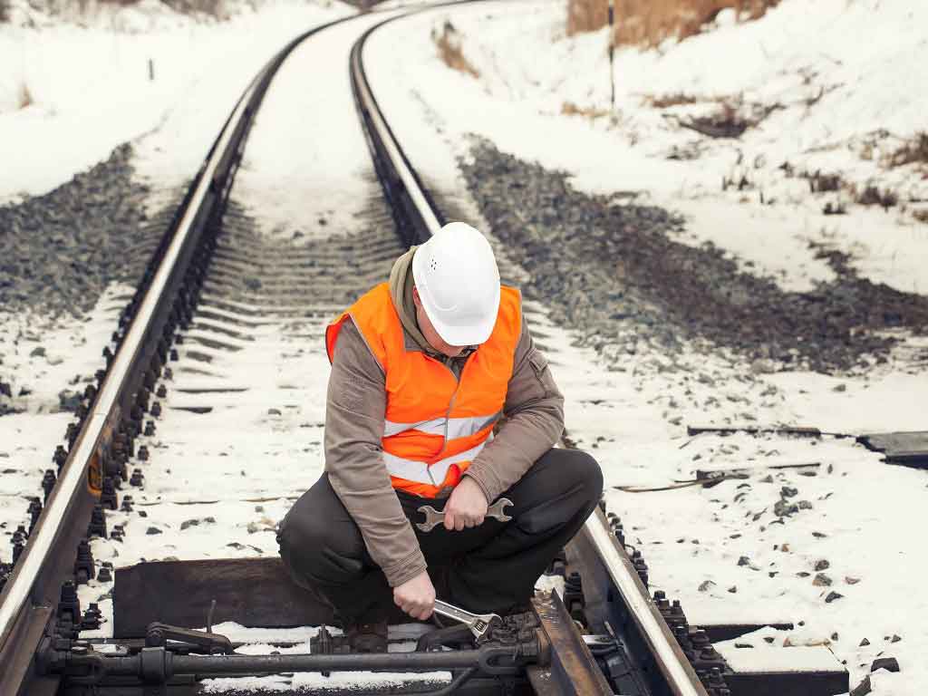 A mechanic working in a train track