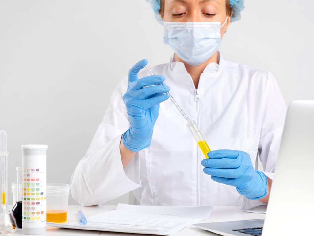 A lab technician performing an alcohol urine test