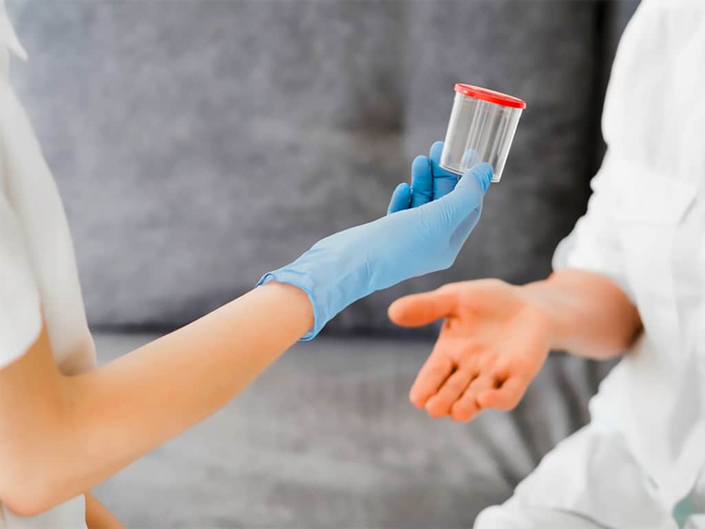 A professional handing a sterile container to a person