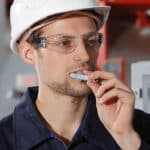 A man putting a swab stick in his mouth for a drug test