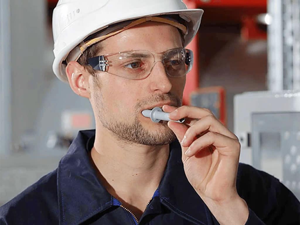 A man putting a swab stick in his mouth for a drug test